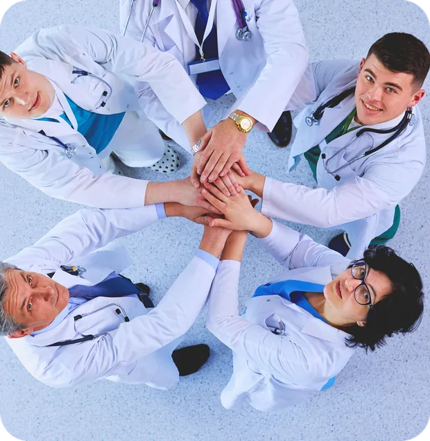 A team of physicians joining hands